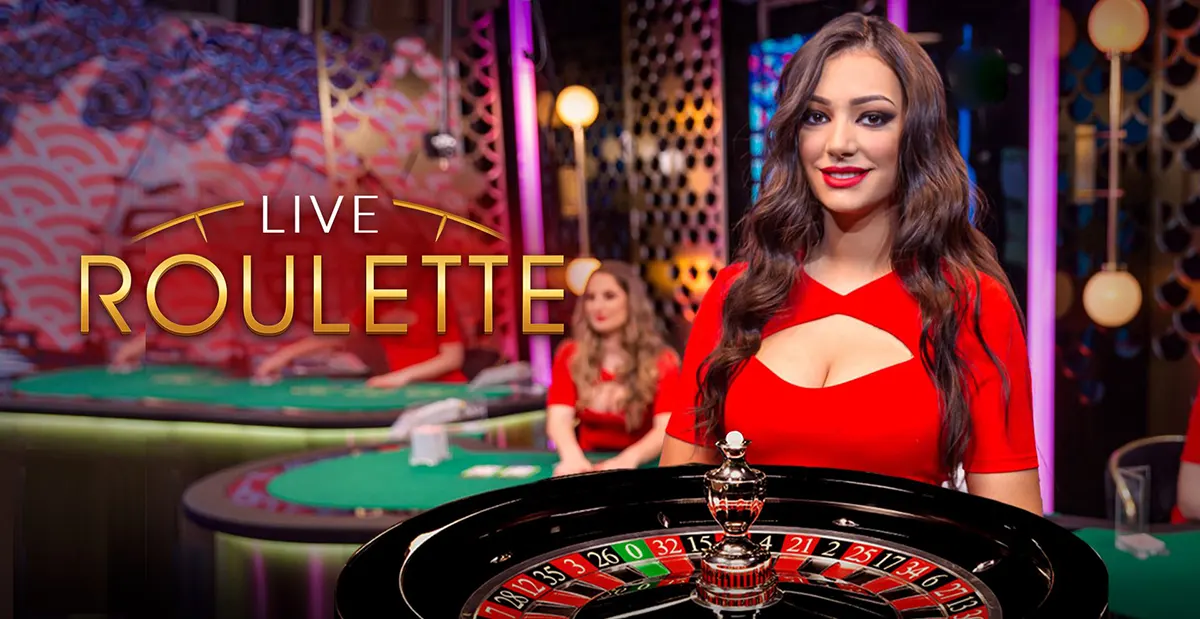 Live roulette promo image showing a smiling croupier in a red dress standing beside a roulette wheel, with “Live Roulette” text and a colourful casino studio with tables and dealers in the background.
